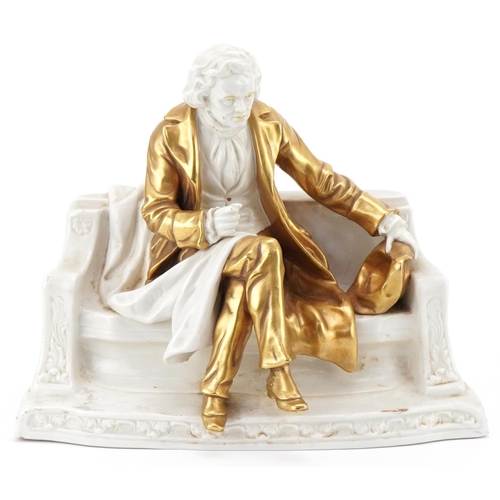 197 - Continental porcelain model of a seated gentleman on a bench wearing a gold coat and hat, numbered 1... 