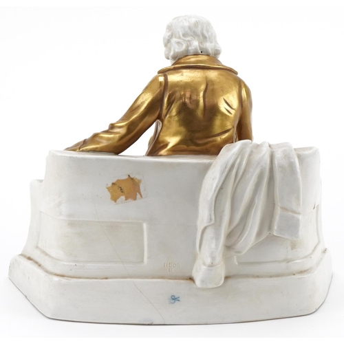 197 - Continental porcelain model of a seated gentleman on a bench wearing a gold coat and hat, numbered 1... 