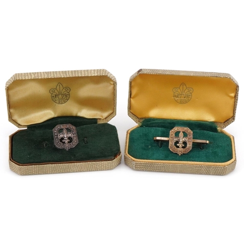 Boxed silver Boy Scout's stud together with a boxed silver badge