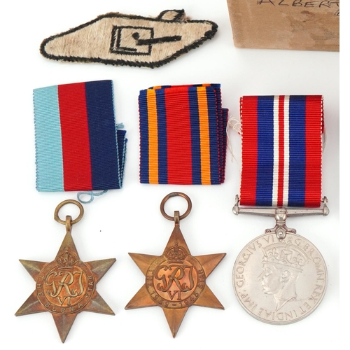 1510 - British Military interest World War II medals for Albert Edward Joyce, Tank Corps badges and patches