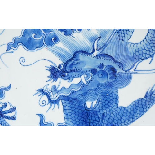 174 - Chinese porcelain blue and white plate hand painted with a dragon chasing a flaming pearl, 27cm in d... 