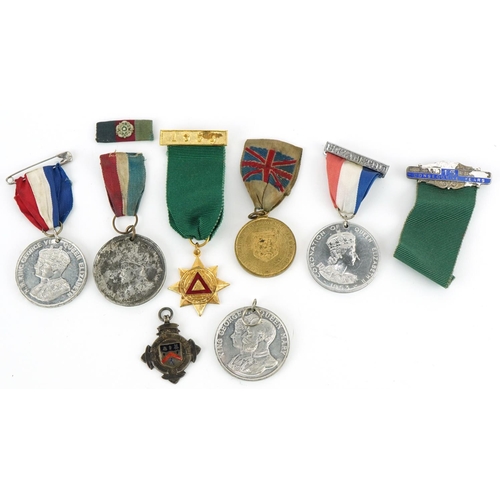 1337 - Five Coronation medallions, a 1955 driving award and a silver and enamel sports jewel