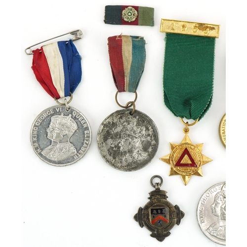 1337 - Five Coronation medallions, a 1955 driving award and a silver and enamel sports jewel