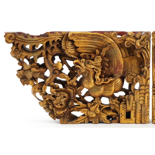 355 - Pair of Chinese gilt painted wood brackets carved with phoenixes amongst foliage, each 28.5cm high x... 