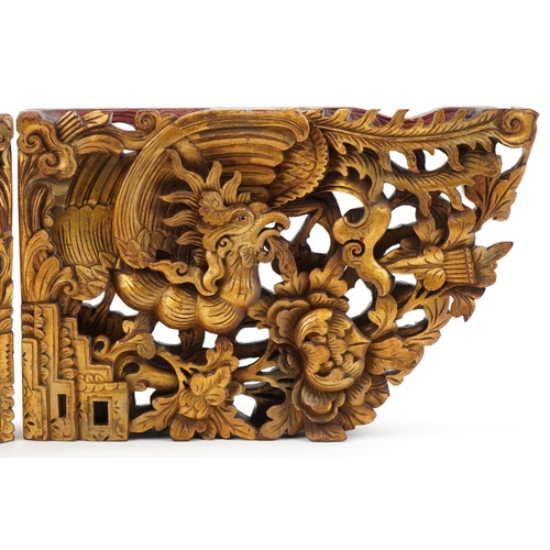 355 - Pair of Chinese gilt painted wood brackets carved with phoenixes amongst foliage, each 28.5cm high x... 