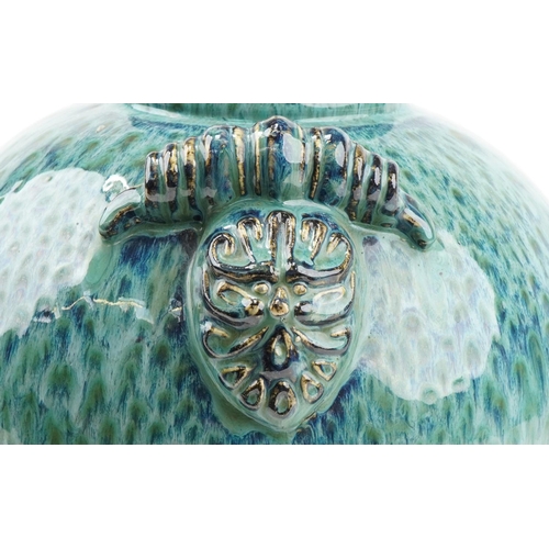 1175 - Large pottery table lamp having turquoise glaze and twin lion mask handles, 46cm high