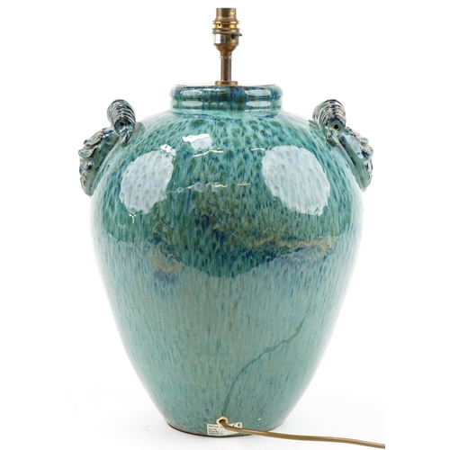 1175 - Large pottery table lamp having turquoise glaze and twin lion mask handles, 46cm high