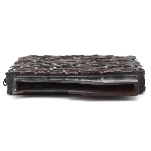 179 - Chinese tortoiseshell card case base profusely carved with figures, pagodas and trees, 10cm x 7.5cm