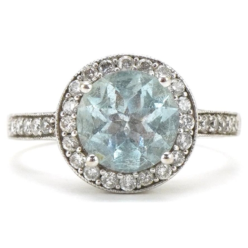 14ct white gold aquamarine and diamond ring with diamond set shoulders, the aquamarine approximately 8.0mm in diameter, each diamond approximately 1.20mm in diameter, size N/O, 4.2g