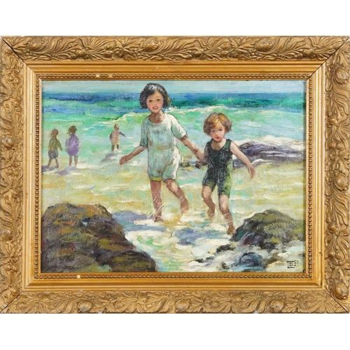 57 - Children playing in the ocean, oil on board, bearing the monogram DS, gilt framed, 38.5cm x 28cm