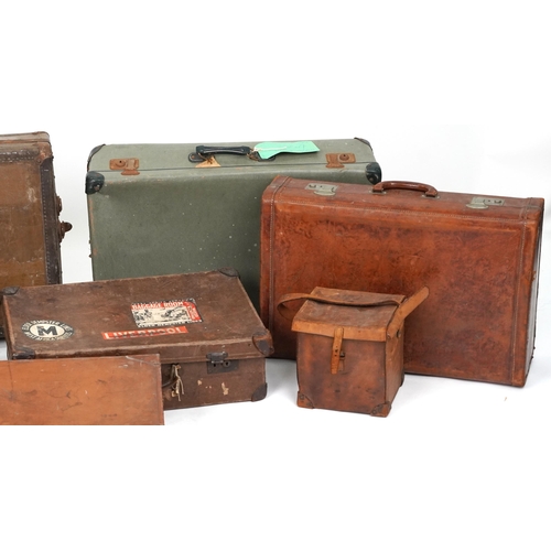 406 - Eight vintage and later suitcases, some leather, the largest 76cm wide