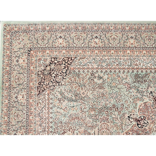 1032 - Super Keshan Turkish rug having an allover floral design onto a green and red ground, 300cm x 200cm