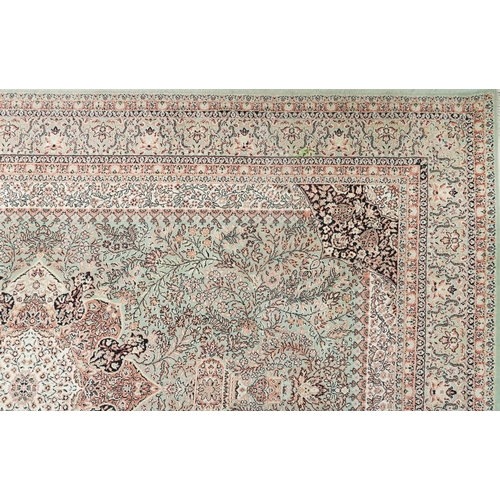 1032 - Super Keshan Turkish rug having an allover floral design onto a green and red ground, 300cm x 200cm