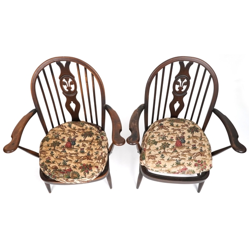 1017 - Two Ercol elm stick back open armchairs with Prince of Wales feather carved backs, each 80cm high