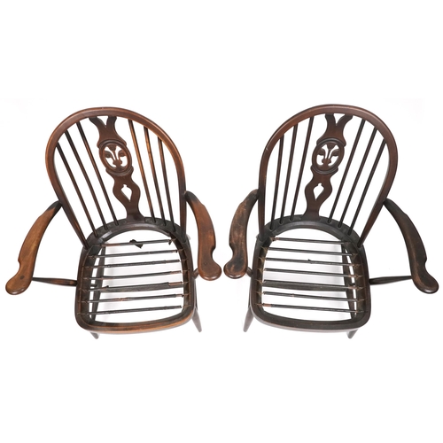 1017 - Two Ercol elm stick back open armchairs with Prince of Wales feather carved backs, each 80cm high