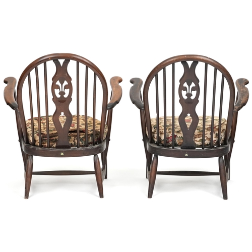 1017 - Two Ercol elm stick back open armchairs with Prince of Wales feather carved backs, each 80cm high