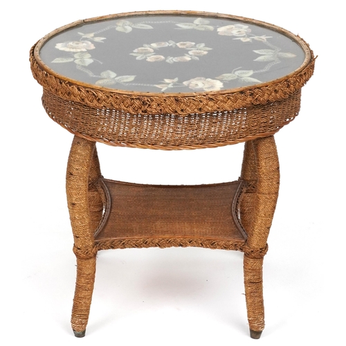 1014 - Cane and wicker occasional table with needlepoint upholstered top and under tier, 55cm high x 56cm i... 