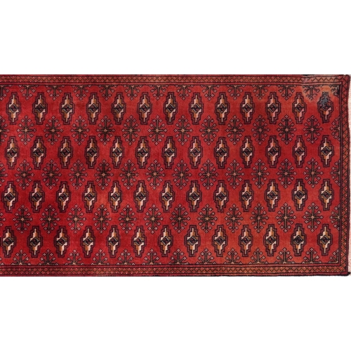 1031 - Rectangular carpet runner having an allover geometric design onto a red and blue ground, 330cm x 69c... 