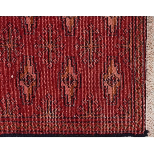 1031 - Rectangular carpet runner having an allover geometric design onto a red and blue ground, 330cm x 69c... 