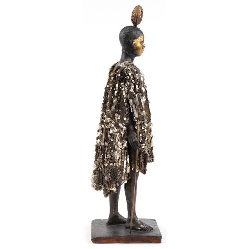 1091 - African carved wood nude female wearing a sequinned dress, 64cm high