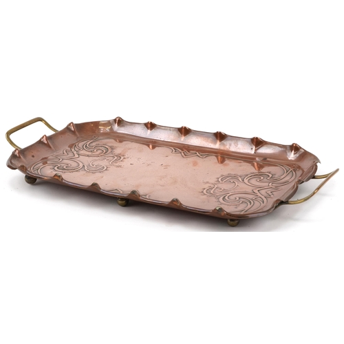 173 - Arts & Crafts copper and brass tray with stylized decoration mounted on small brass feet, impressed ... 