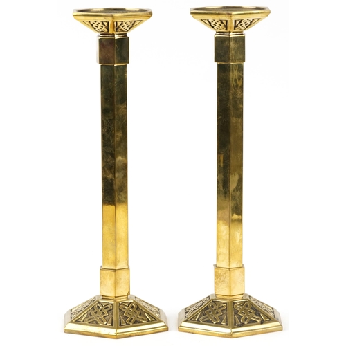 85 - Pair of brass Arts & Crafts Gothic style candlesticks, each 39cm high