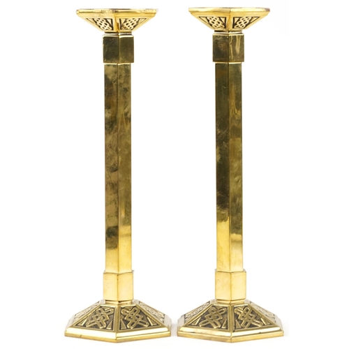 85 - Pair of brass Arts & Crafts Gothic style candlesticks, each 39cm high