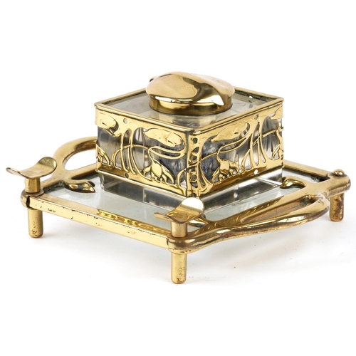 489 - German Arts & Crafts brass and glass inkstand with stylized floral design, 20cm in diameter