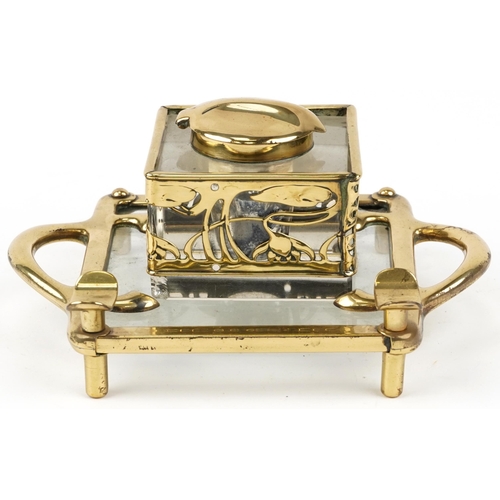 489 - German Arts & Crafts brass and glass inkstand with stylized floral design, 20cm in diameter