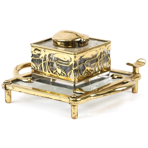 489 - German Arts & Crafts brass and glass inkstand with stylized floral design, 20cm in diameter