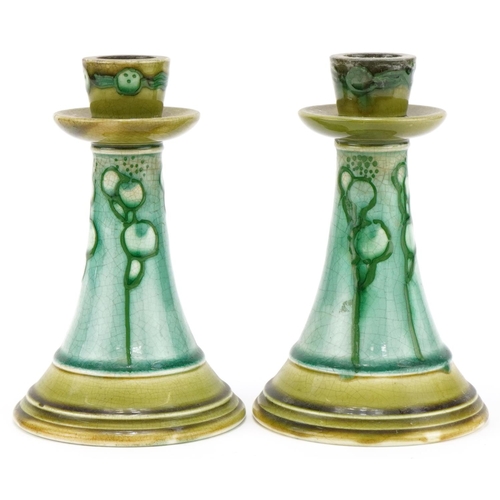 194 - Pair of Minton's Secessionist pottery candlesticks with stylized pattern each 18cm high