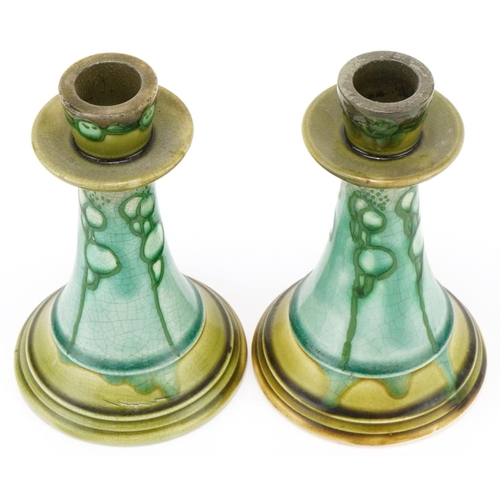 194 - Pair of Minton's Secessionist pottery candlesticks with stylized pattern each 18cm high