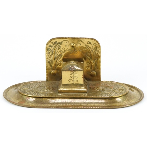 134 - Arts & Crafts brass inkwell decorated with stylized flowers, 30cm in diameter