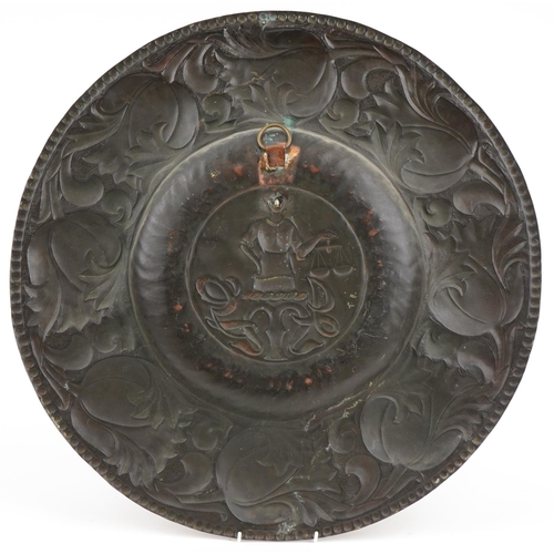 125 - Large Arts & Crafts copper charger the central panel JMG and a man holding scales, 60cm in diameter