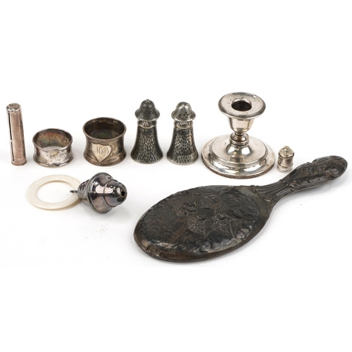 1272 - Silver and silverplate including a hand mirror embossed with Putti, dwarf candlestick, babies rattle... 