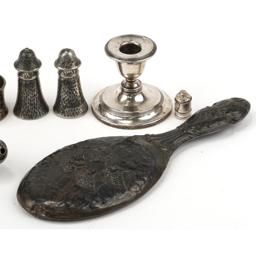 1272 - Silver and silverplate including a hand mirror embossed with Putti, dwarf candlestick, babies rattle... 