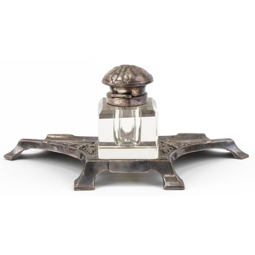 495 - WMF style silver plated ink stand with cut glass bottle, decorated with acorns, 21cm in diameter