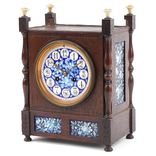 160 - Arts & Crafts oak mantle clock inset with floral enamelled porcelain tiles, the French movement stri... 