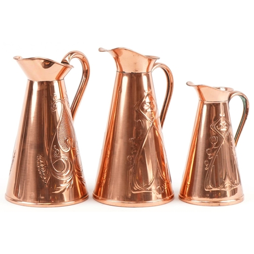 153 - Three Arts & Crafts copper jugs, two stamped J S & S, the largest 30cm high