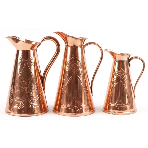 153 - Three Arts & Crafts copper jugs, two stamped J S & S, the largest 30cm high