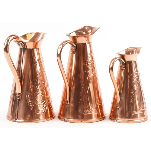 153 - Three Arts & Crafts copper jugs, two stamped J S & S, the largest 30cm high