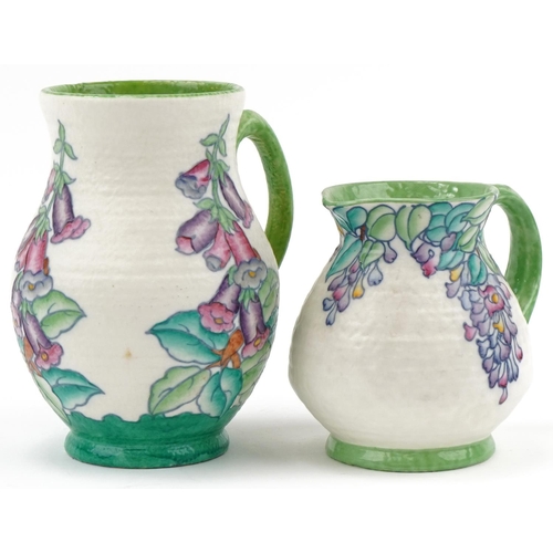 411 - Two Charlotte Rhead for Crown Ducal floral jugs signatures and numbered 4953 to the bases, the large... 