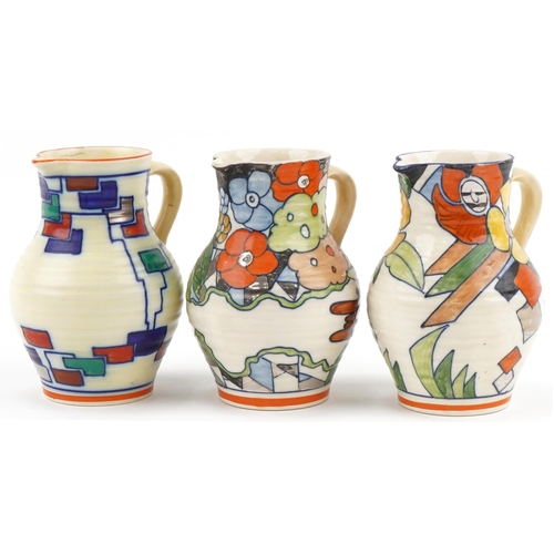 325 - Three Charlotte Rhead for Wardle Swansea Ware Flora pattern floral jugs, the largest 17cm high