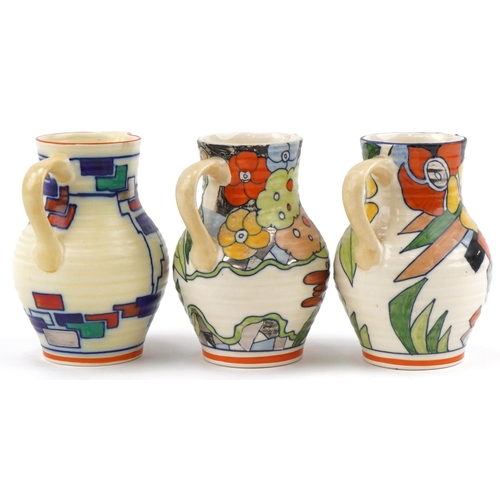 325 - Three Charlotte Rhead for Wardle Swansea Ware Flora pattern floral jugs, the largest 17cm high