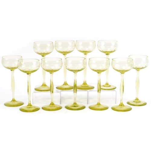 527 - Eleven stylish lime green stemmed wine glasses etched with berries, 18cm high