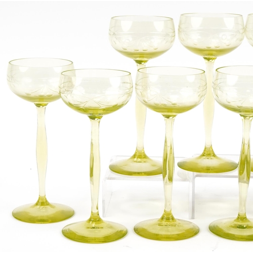 527 - Eleven stylish lime green stemmed wine glasses etched with berries, 18cm high