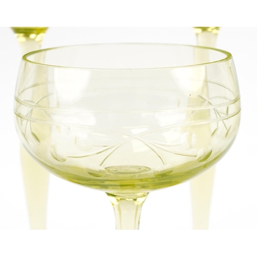 527 - Eleven stylish lime green stemmed wine glasses etched with berries, 18cm high