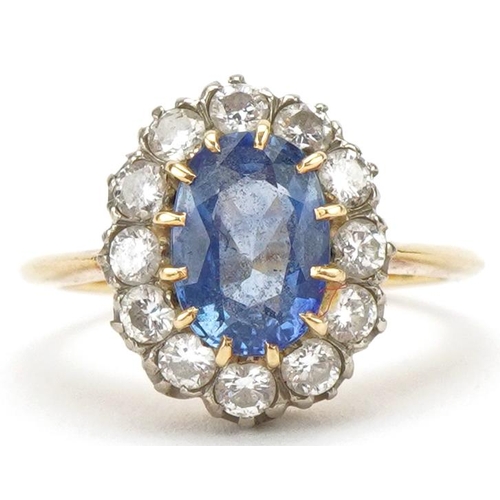 3007 - 18ct gold sapphire and diamond cluster ring, the sapphire approximately 8.70mm x 6.10mm x 4.10mm dee... 