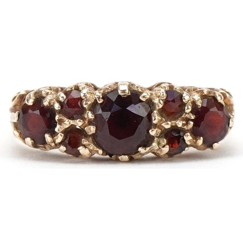 3179 - Victorian style 9ct gold garnet cluster ring with ornate setting, size N, 2.2g