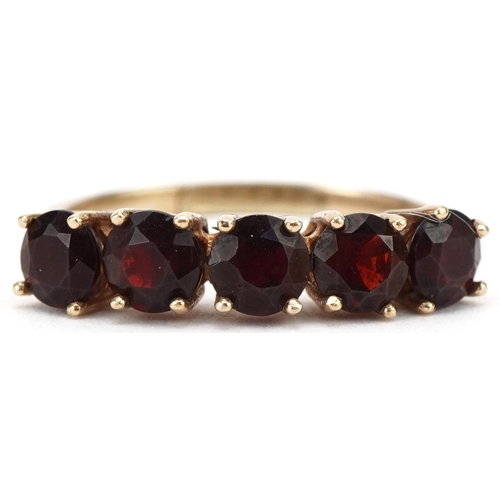 3196 - Unmarked gold garnet five stone ring, size R, 3.6g